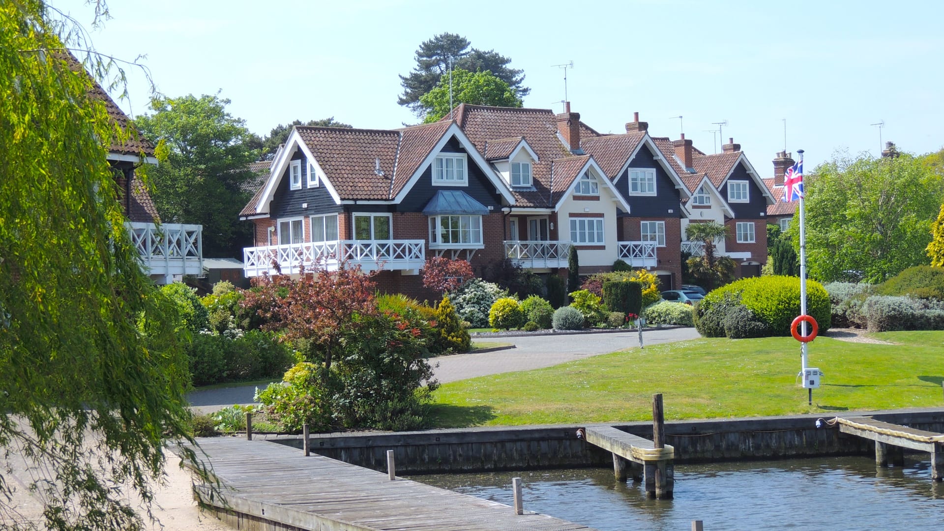 Waterside houses beside a marina, illustrative