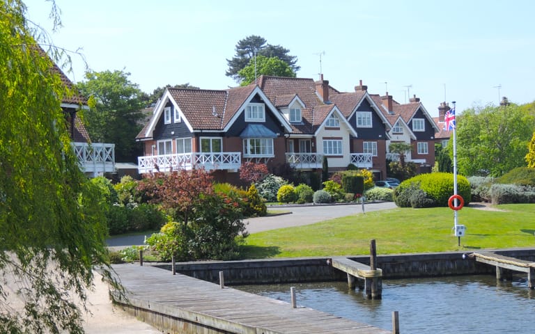 Waterside houses beside a marina, illustrative