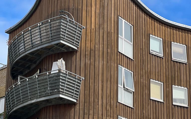 Low-rise apartment block with balconies, illustrative