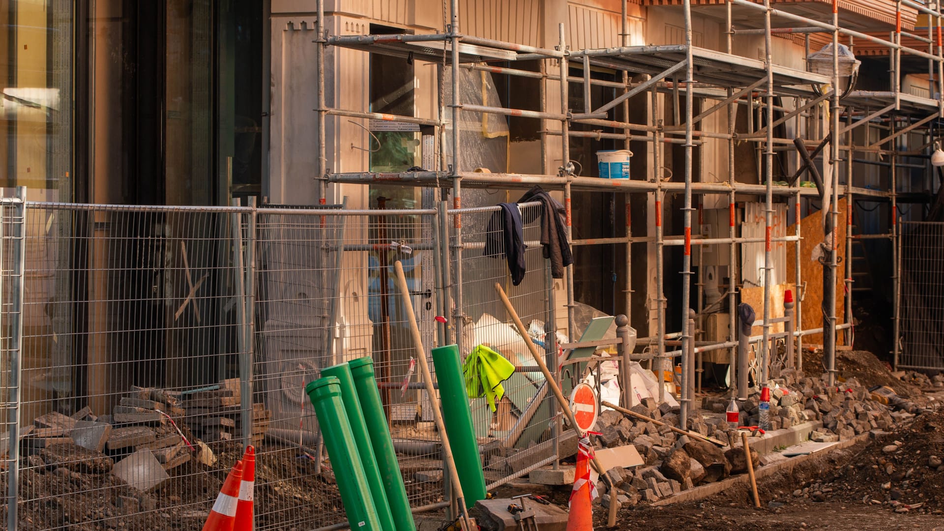 Building site with scaffolding and barriers, illustrative