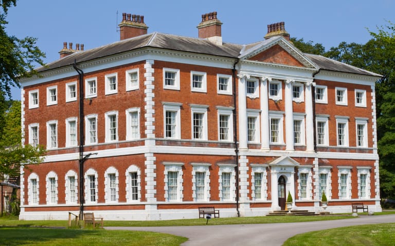 Georgian brick country house with lawns, illustrative
