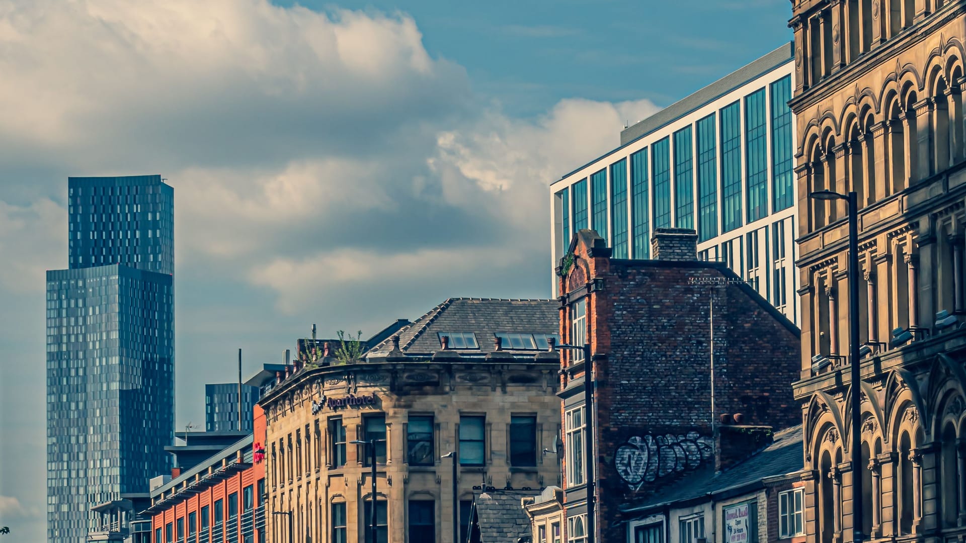 City-centre street with period and modern buildings, illustrative