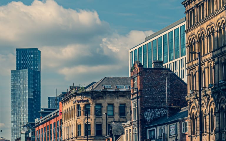 City-centre street with period and modern buildings, illustrative