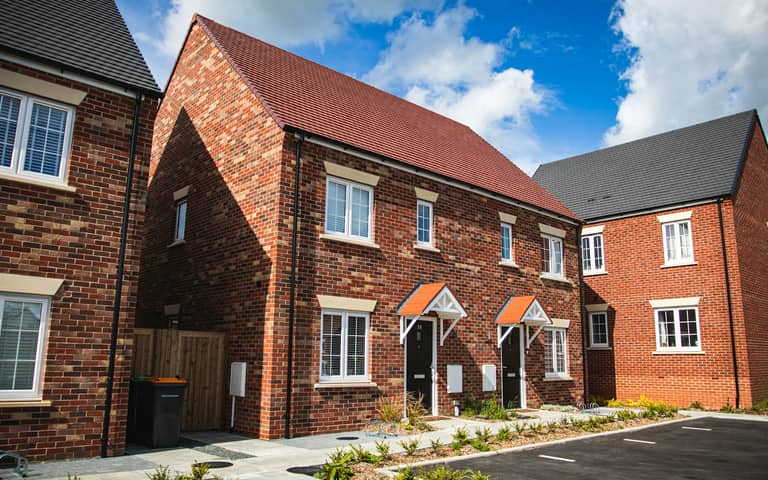 New-build brick homes on an estate, illustrative