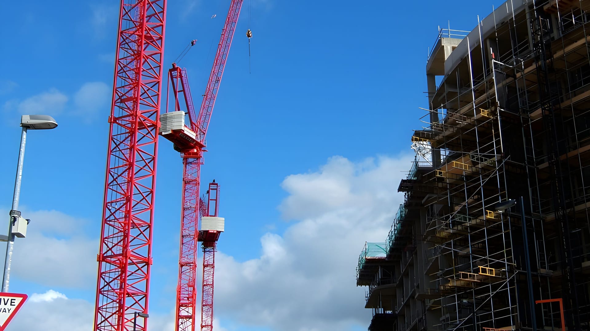 Tower cranes over a construction site, illustrative