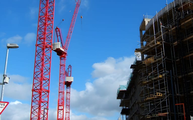 Tower cranes over a construction site, illustrative